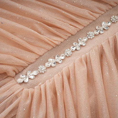 Mini dress, gathered and decorated with stones.