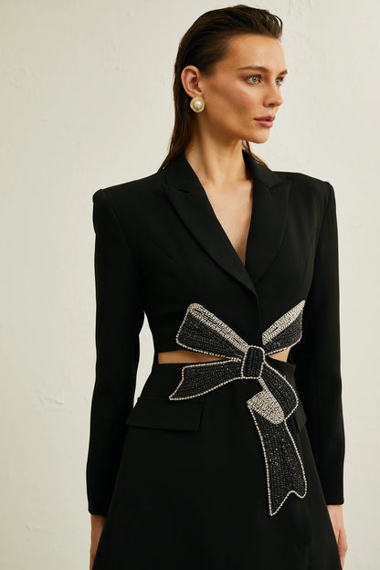 Beautiful jacket with bow decorated with diamonds.